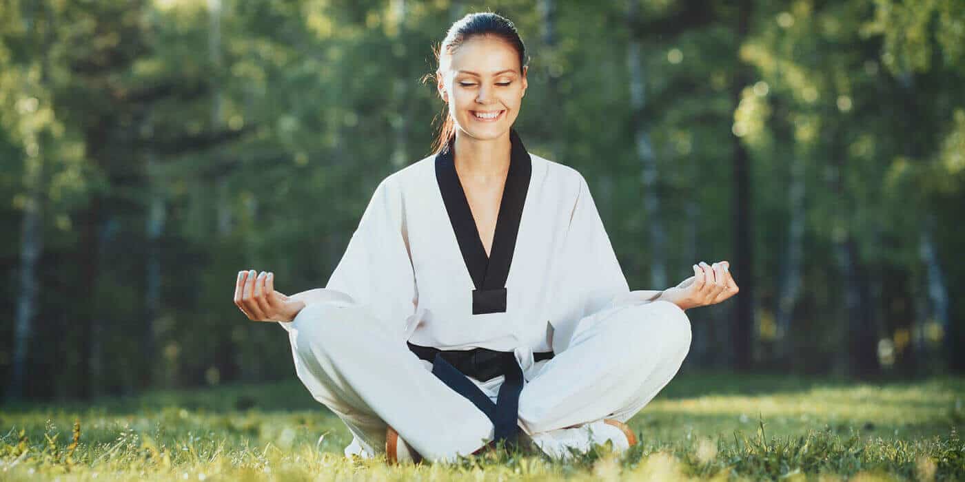 Martial Arts Lessons for Adults in Katy TX - Happy Woman Meditated Sitting Background